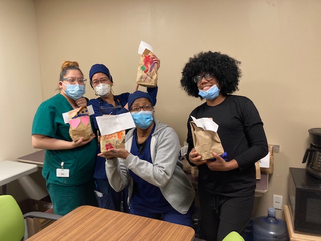 Nurses holding brown bags