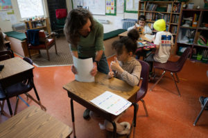 Teacher and Student Interacting in classroom setting