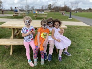 Kids sitting on bench table with face paint